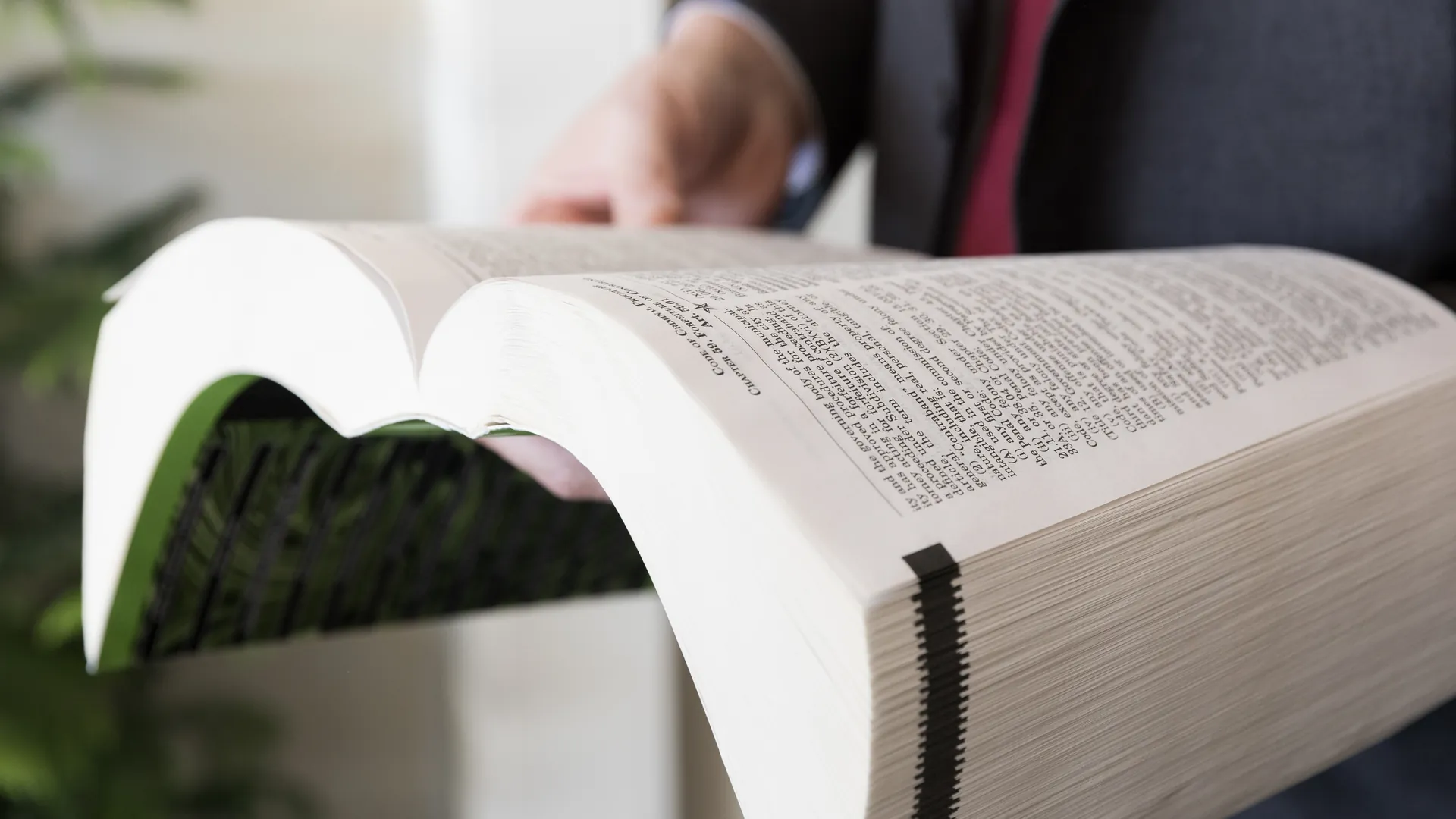 Joe Vrechek turning the pages of a law book